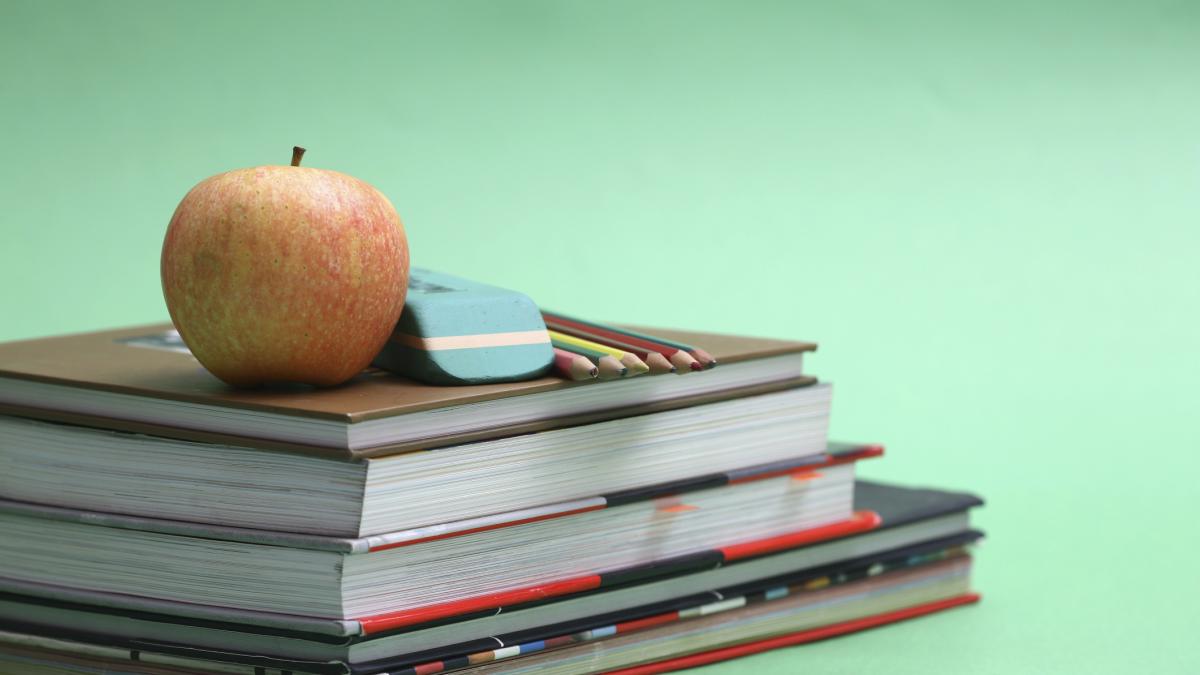 school books, apple and art pencils